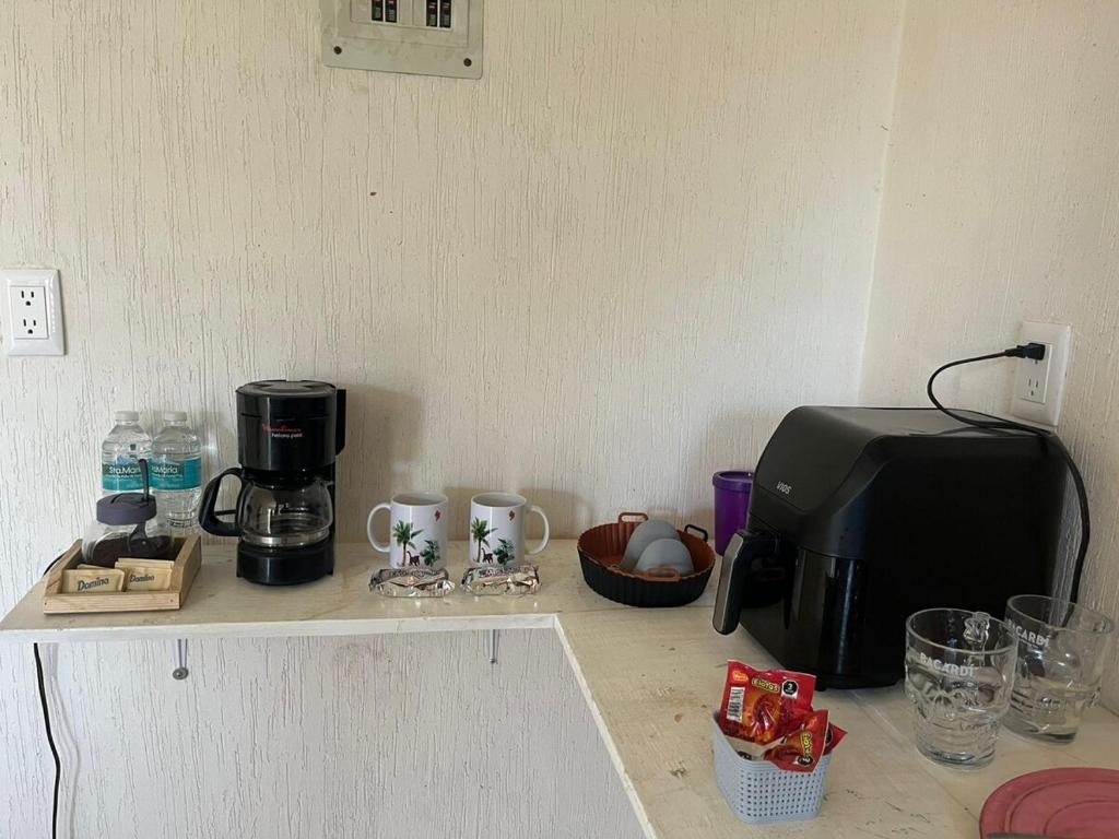 a counter top with a coffee maker and a toaster at Casa Claliz in Los Algodones