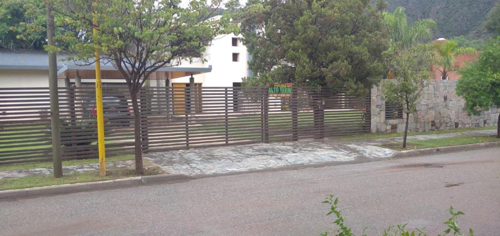 a fence on the side of a road next to a street at Posada Alto Verde in Belén