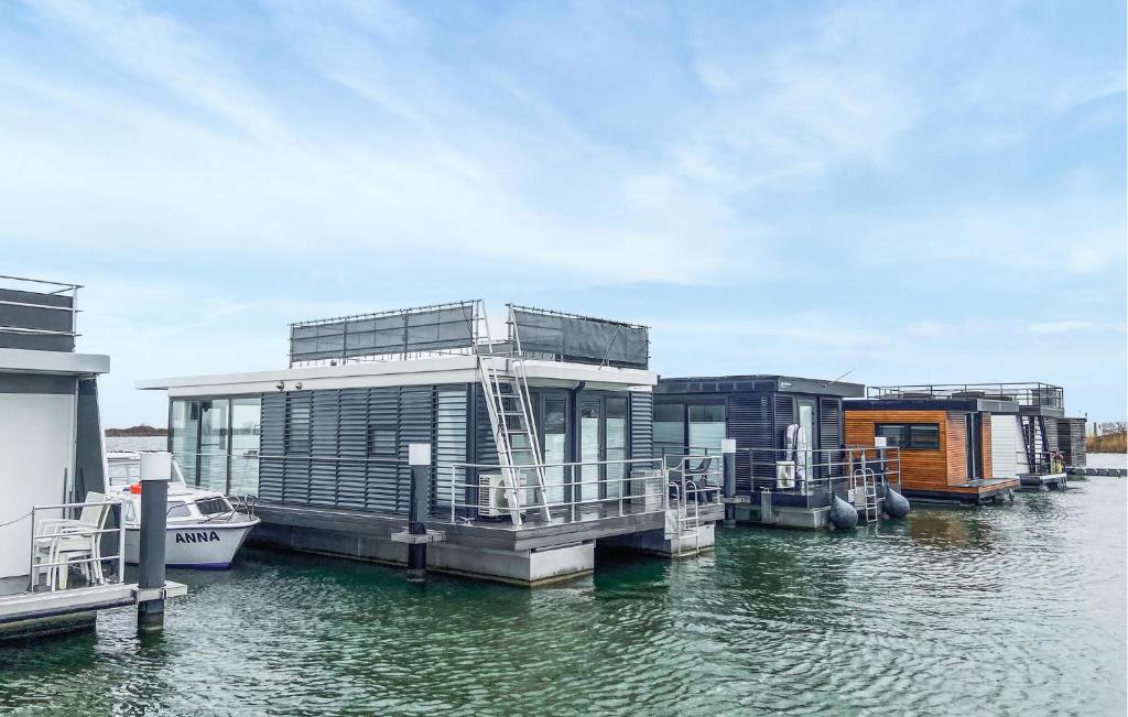 a group of houses on a dock in the water at 2 Bedroom Nice Ship In Lelystad in Lelystad