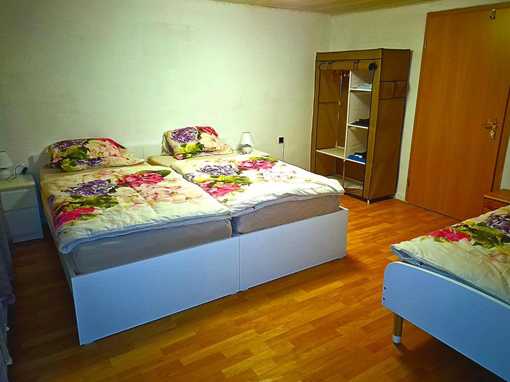 a bedroom with two beds and a mirror at Ferien & Monteure Residence in Schauenburg