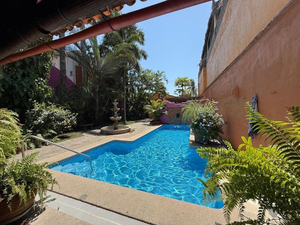 a swimming pool in a yard next to a building at Casa Sorpresa in Sayulita