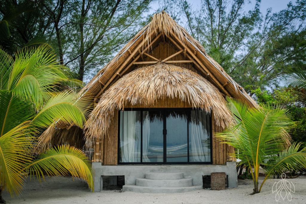 a small hut with a thatched roof and a window at MUUN experience in Ciudad del Carmen