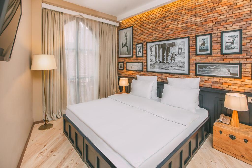 Postel nebo postele na pokoji v ubytování Kisi Boutique Hotel