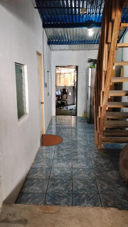 a hallway with a tile floor and a staircase at SWELL house, EL TUNCO in El Sunzal