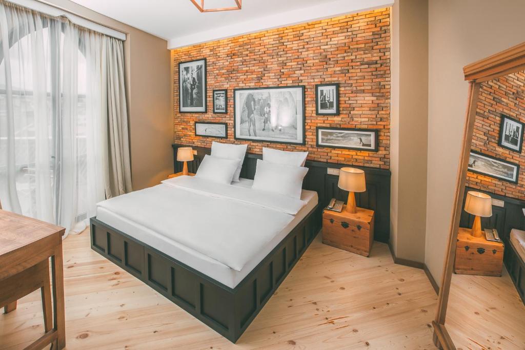 Postel nebo postele na pokoji v ubytování Kisi Boutique Hotel