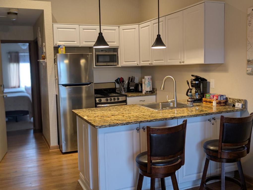 a kitchen with a sink and a counter with chairs at C & D Restawhile in Oak Harbor