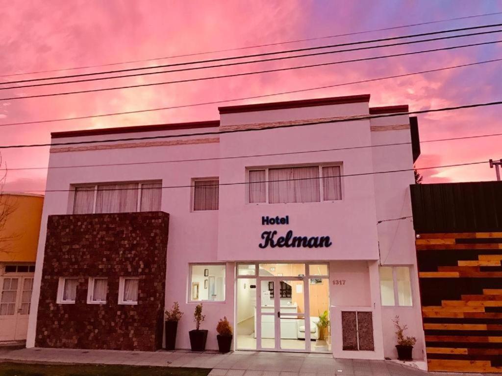 a white building with a sign that reads head hall istg at KELMAN Hotel in Perito Moreno