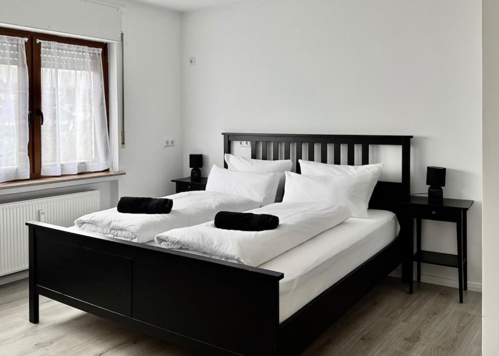a bedroom with a large bed with white pillows at PW38 Studio Koblenz in Koblenz