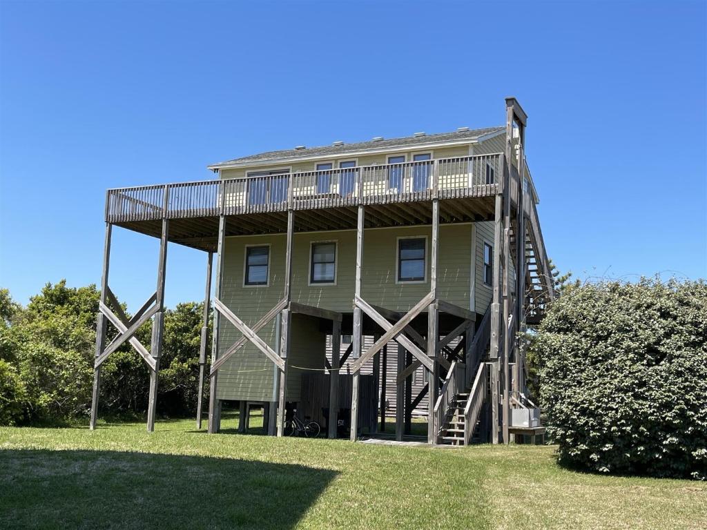 a large house with a deck on the side of it at SOUTHERN STAR cottage in Hatteras