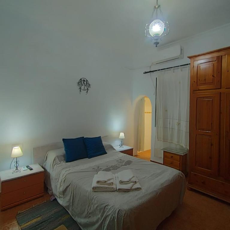 a bedroom with a bed with two towels on it at ALBORADA TRES in Burguillos