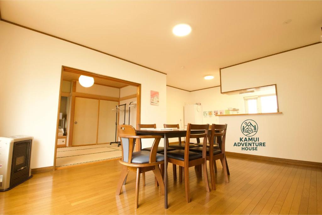 a dining room with a table and chairs at Kamui Adventure House in Asahikawa
