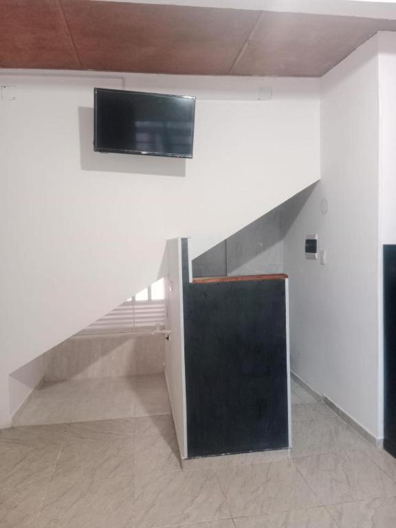 a staircase with a flat screen tv on the wall at Apartaestudio in Chiquinquirá