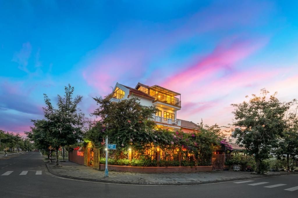 a building on the side of a street at dusk at Nova Vista Villa Hoi An in An Bàn (2)