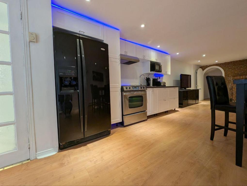 a kitchen with a refrigerator and a table and chairs at Home rental S7 in Saint Maurice