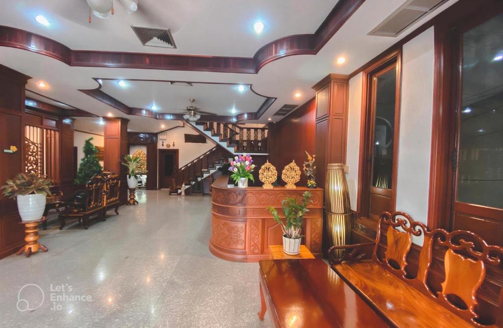a lobby with chairs and a staircase in a building at Khampiane Hotel in Vientiane
