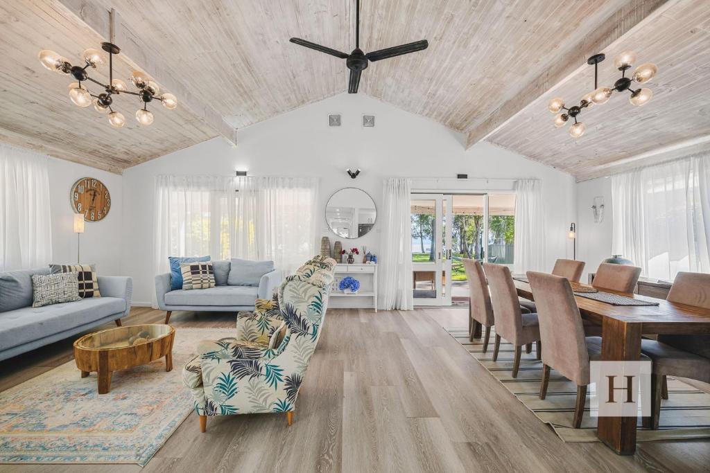 a living room with a couch and a table at Sunset Escape in Summerland Point