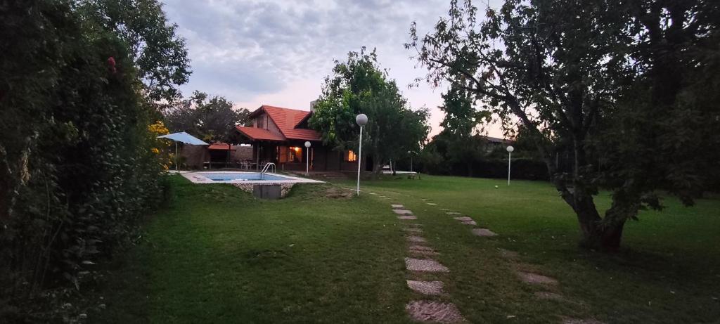 a yard with a swimming pool and a house at Ayün Mawida in Las Compuertas