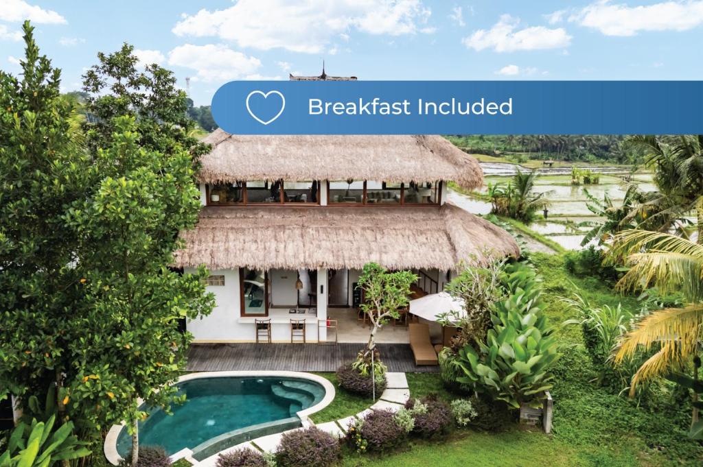 a resort with a swimming pool and a straw hut at Villa Fafa by BaliSuperHost in Ubud