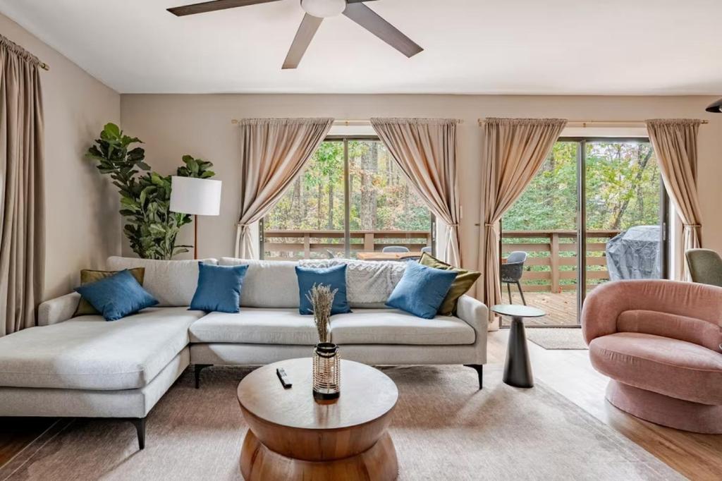 a living room with a couch and a chair at Three Trees Retreat in Ellijay