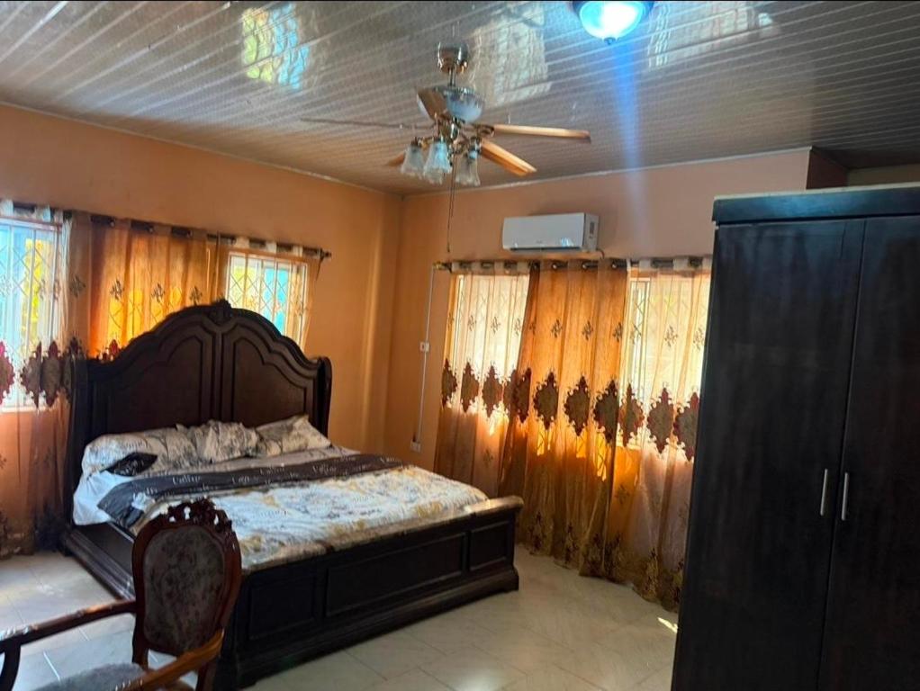 a bedroom with a bed and a ceiling fan at Nuria luxurious one bed room apartment in Sekondi-Takoradi