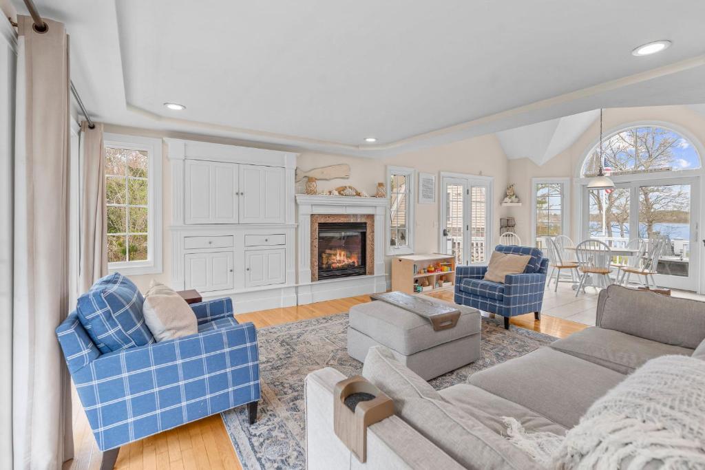 a living room with a couch and chairs and a fireplace at Buzzards Bay Family Beach Firepit CapeCodCanal in Bourne