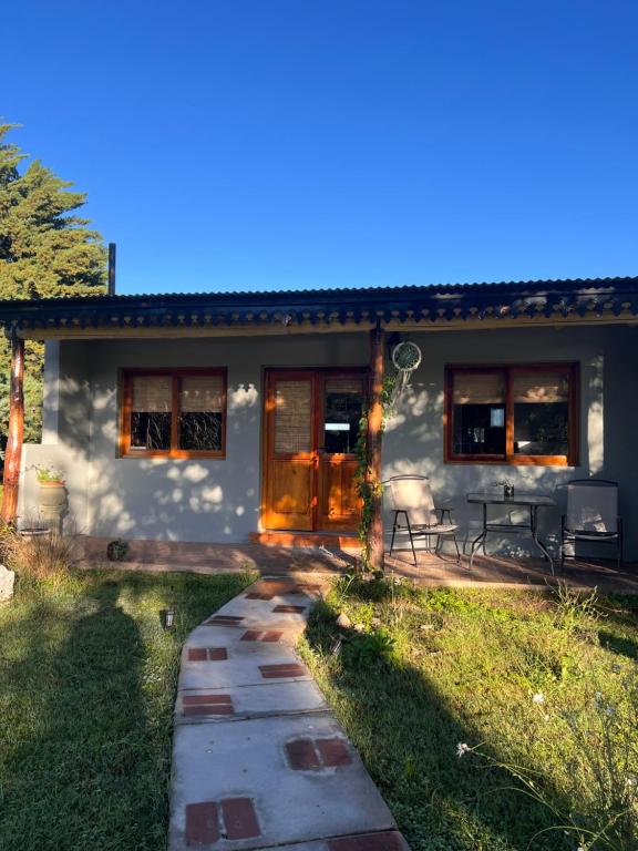 a house with a pathway leading to the front yard at Ranchos de la Tata in Las Calles