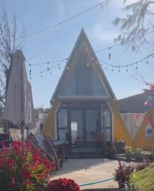 a small house with a pointed roof at Nhu's Cozy Home in Phước Thuận (1)