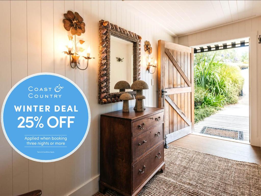 a flyer for a winter deal off of a room with a door at The Winemaker's Cottage - Coast & Country in Omiha