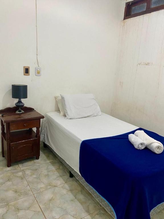 a bedroom with a bed and a table with towels on it at Depto Ibarreta in Ibarreta
