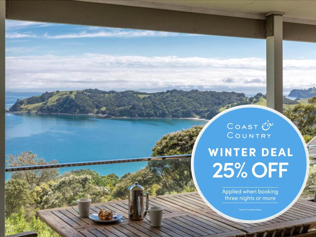 a sign that reads winter deal off with a view of a lake at Piemelon Bay Views - Coast & Country in Onetangi