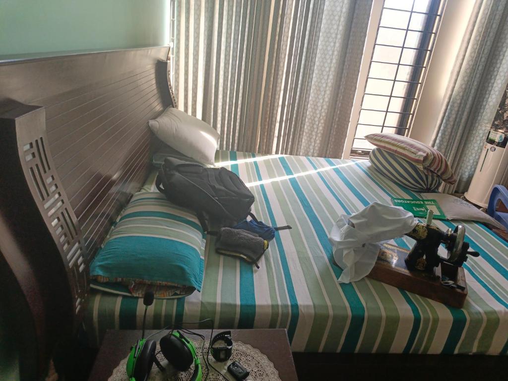 a bedroom with a bed with bags on it at 430 Capital Suites in Islamabad