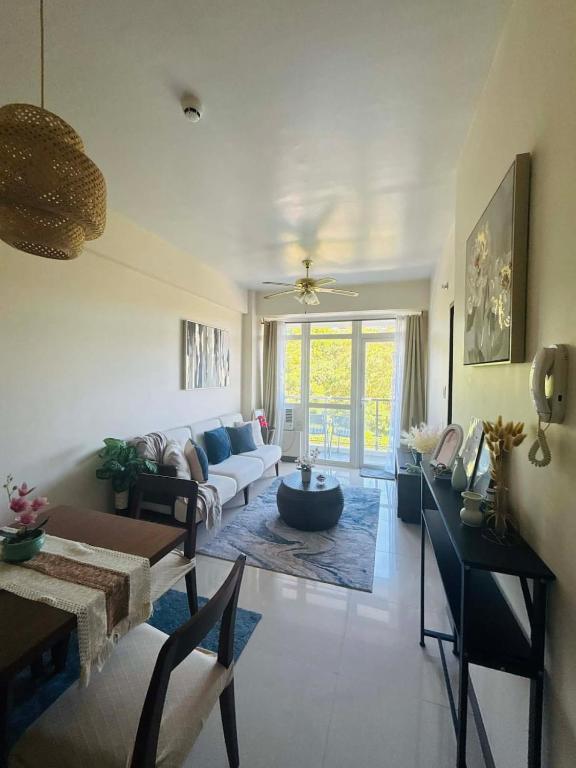 a living room with a couch and a table at Ocean Garden Villas Cluster B 3rd Floor Unit C in Boracay