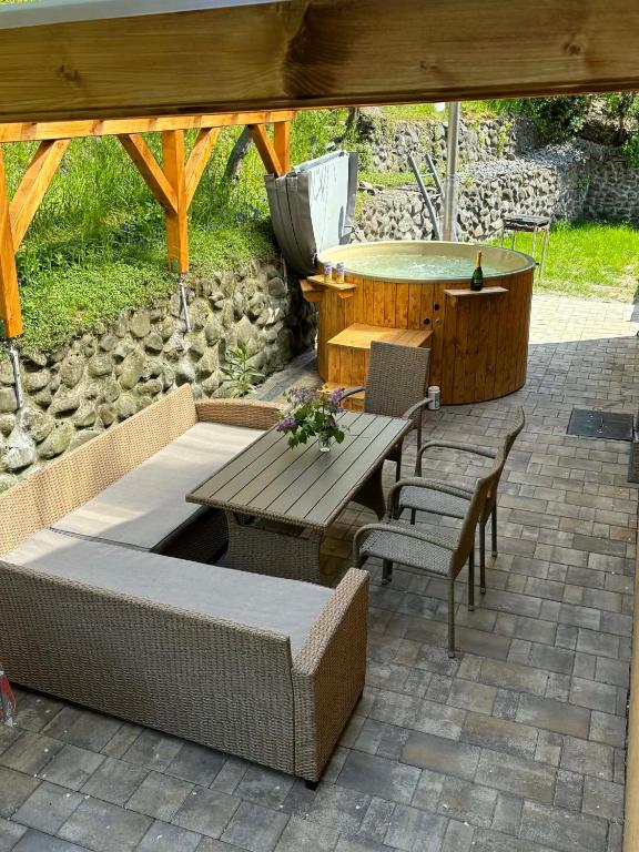 a patio with a picnic table and chairs under a pavilion at Silent House Sovata in Sovata