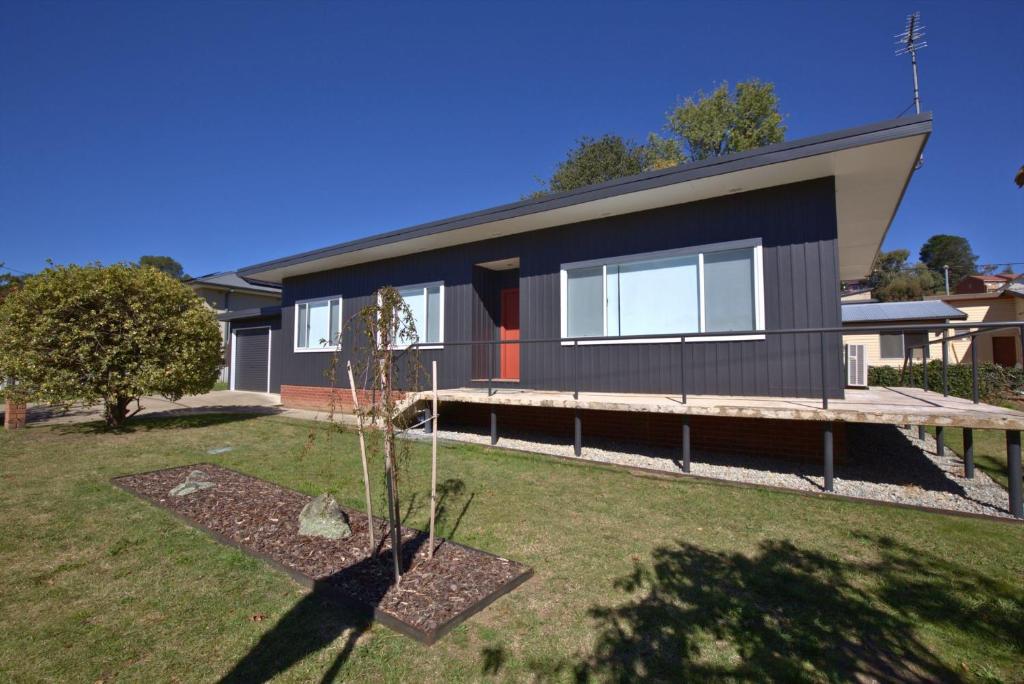 a house with a large yard in front of it at 2 Munyang Street in Jindabyne