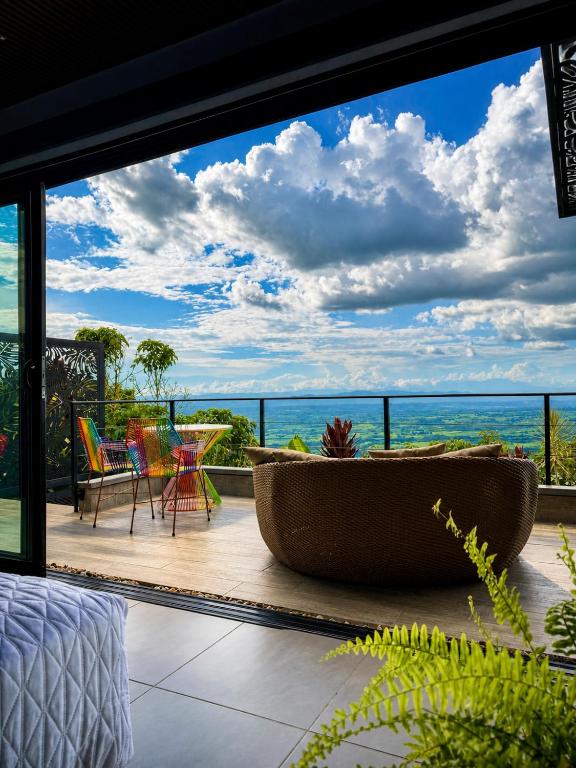 a room with a large window with a view of the ocean at La Font Ecolodge in Buenavista