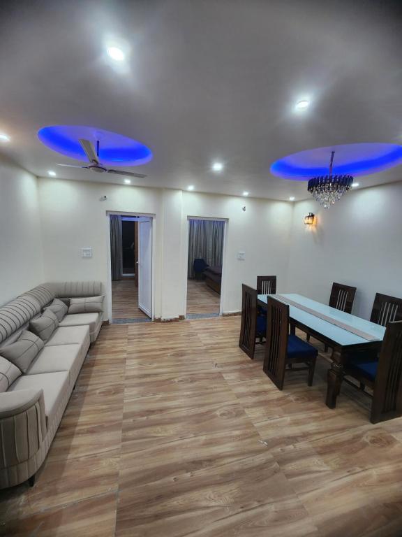 a living room with a couch and a table at Hazy hill in Mussoorie