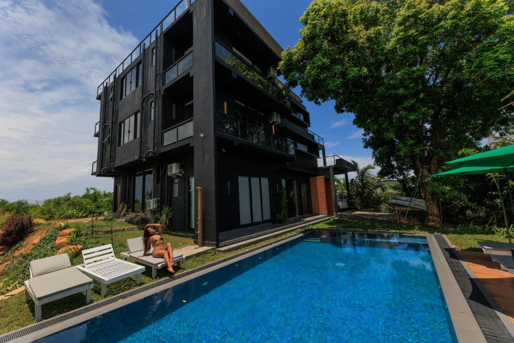 a house with a swimming pool next to a building at Secret Paradise Edge in Weligama