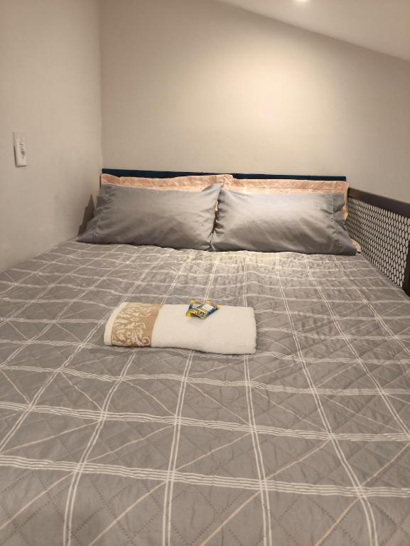 a large bed with a blanket on top of it at Mini Casa 02 - Próx Aeroporto e Centro Hospitalar in Teresina