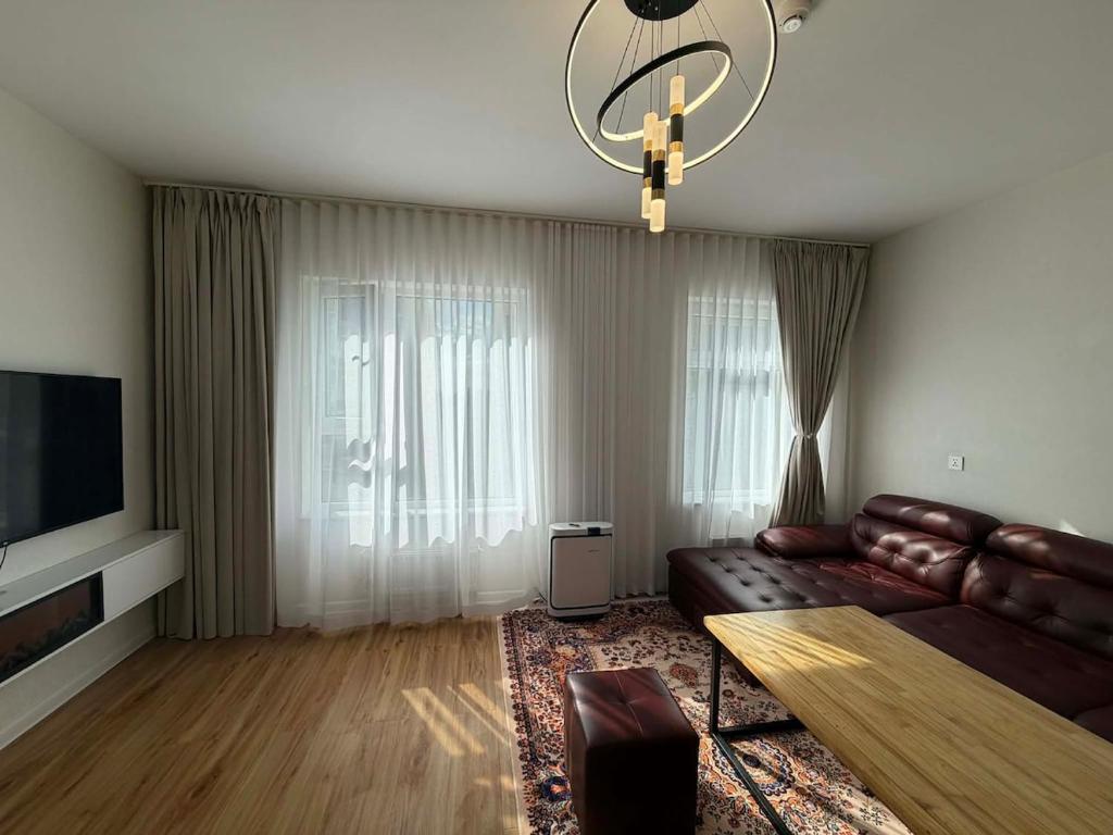 a living room with a leather couch and a television at Modern Luxury Debut - Untouched in Ulaanbaatar