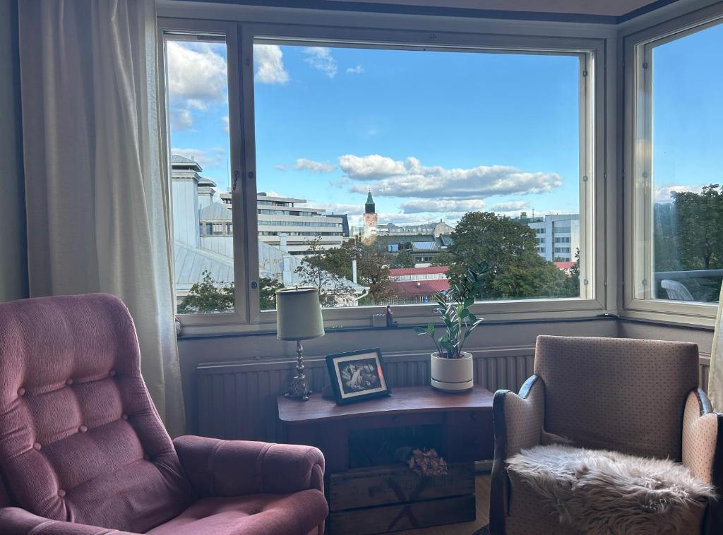 a room with two chairs and a table and a window at ArtBeat Downtown in Turku