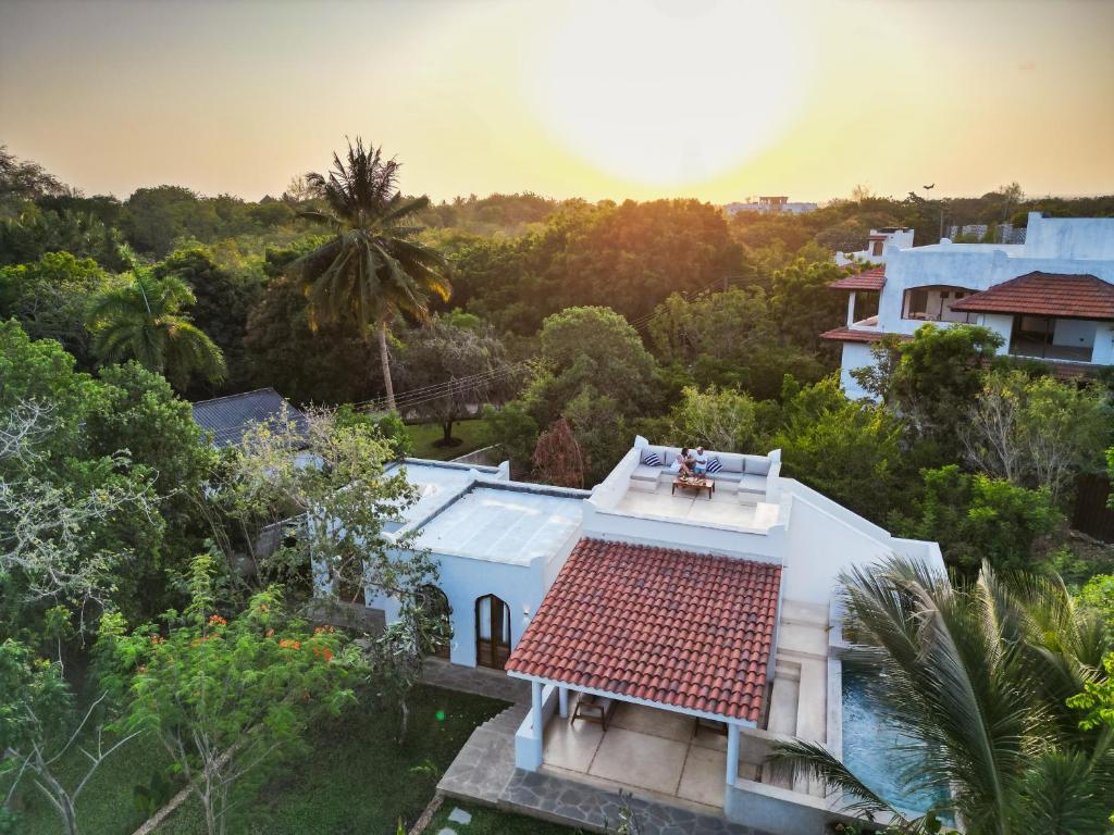 an aerial view of a house with a roof at Little Maua - Stylish Private Hideaway on Galu Beach in Galu