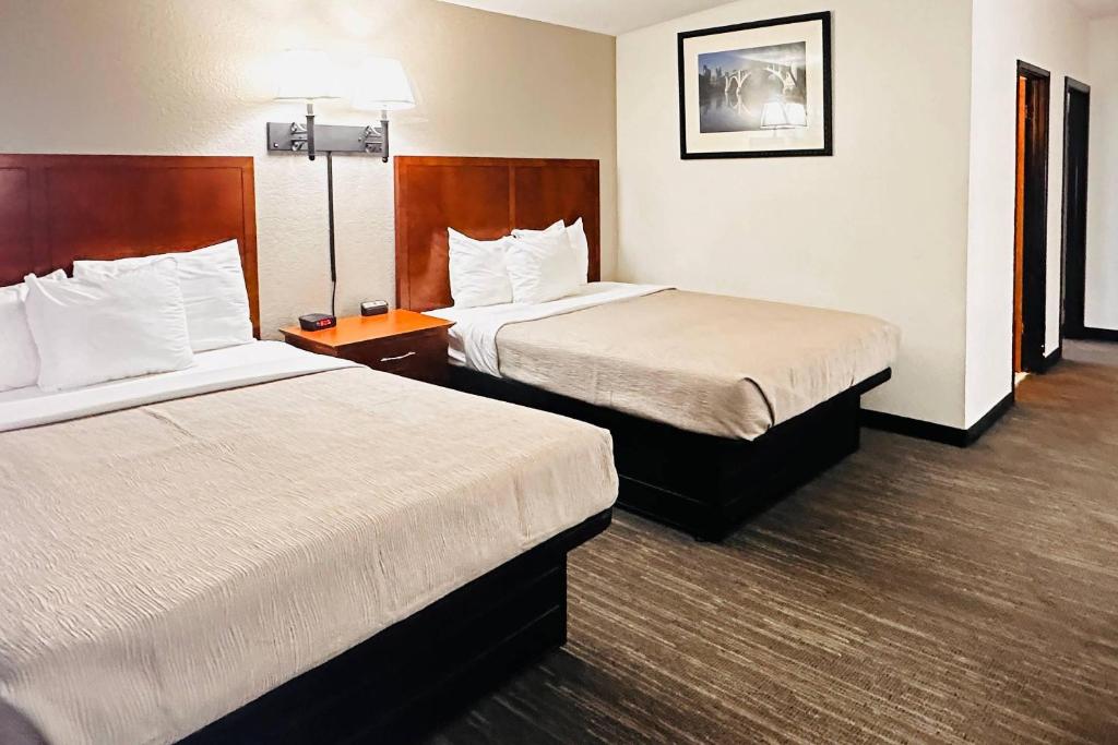 a hotel room with two beds and a lamp at Quality Inn St Paul-Minneapolis-Midway in Saint Paul