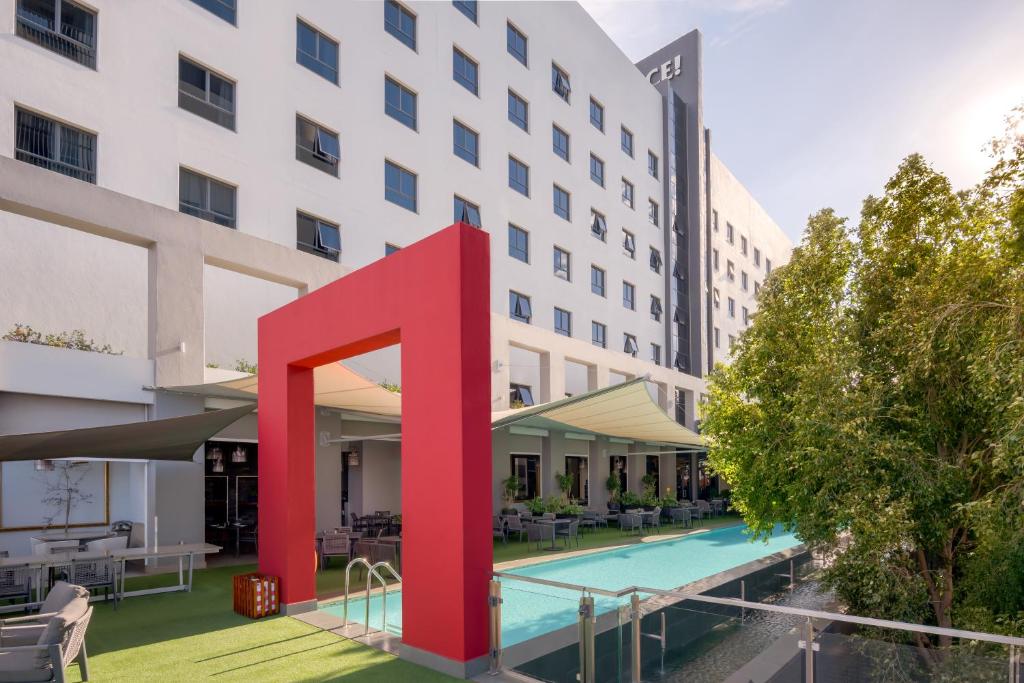 a hotel with a large red letter on the front of a building at Protea Hotel Fire & Ice! by Marriott Pretoria Menlyn in Pretoria
