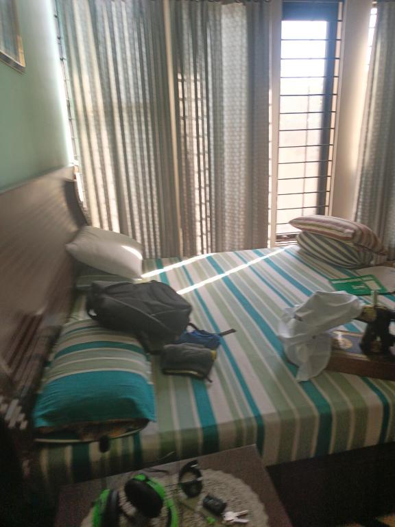 a bedroom with a bed with a striped bedspread at The 430 District in Islamabad