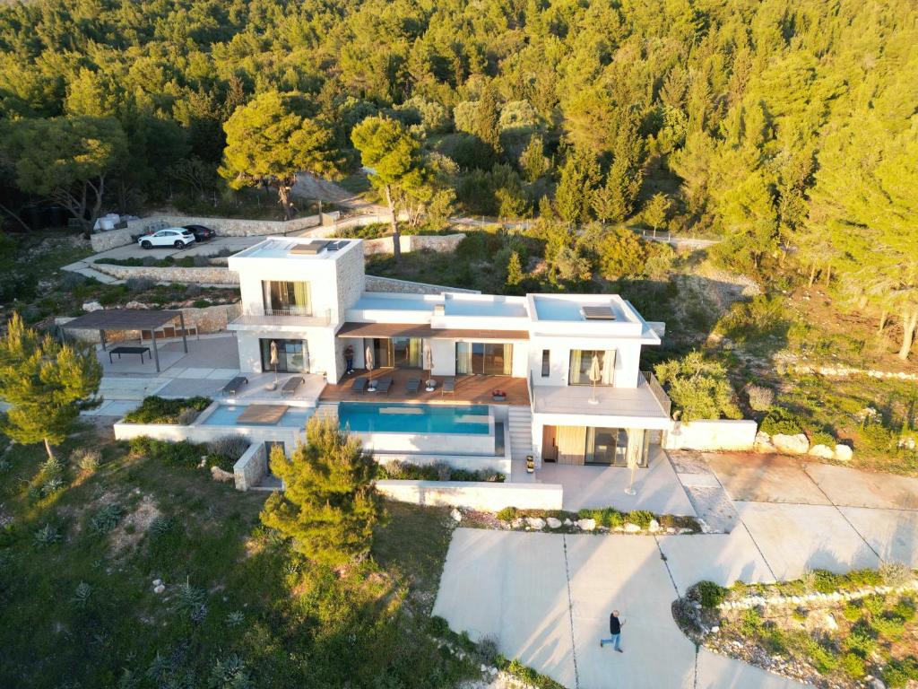 an aerial view of a house with a pool at Villa Pefko in Athani