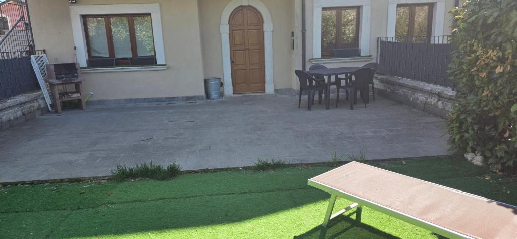 a patio with chairs and a table in front of a house at Relax Pescasseroli For Ever in Pescasseroli