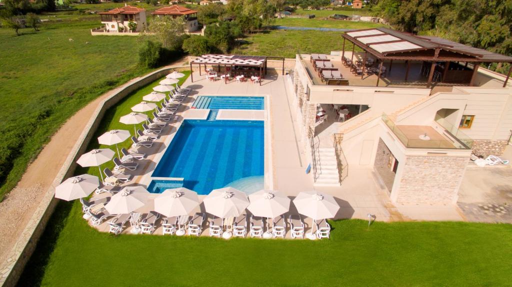 an aerial view of a swimming pool with chairs and umbrellas at Niriides Luxury Villas in Methoni