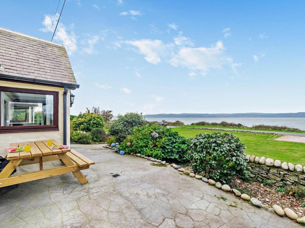 a patio with a picnic table next to a house at 3 Bed in Isle Of Arran oc-93240 in Pirnmill