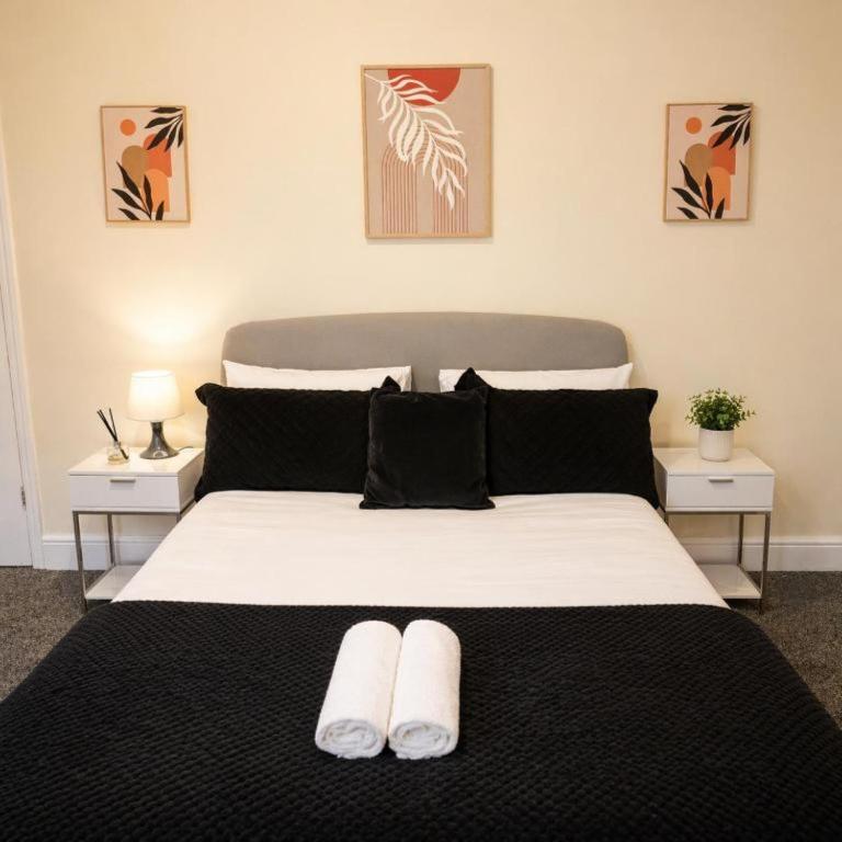 a bedroom with a large bed with two night stands at The Range Nestled Nook in Manchester