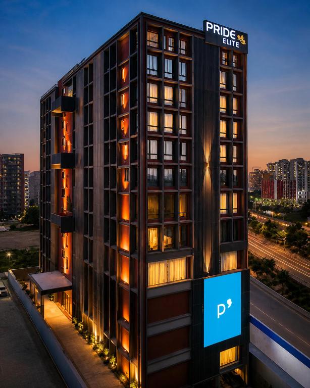 a building with a sign on the side of it at Pride Elite Gandhinagar in Gandhinagar